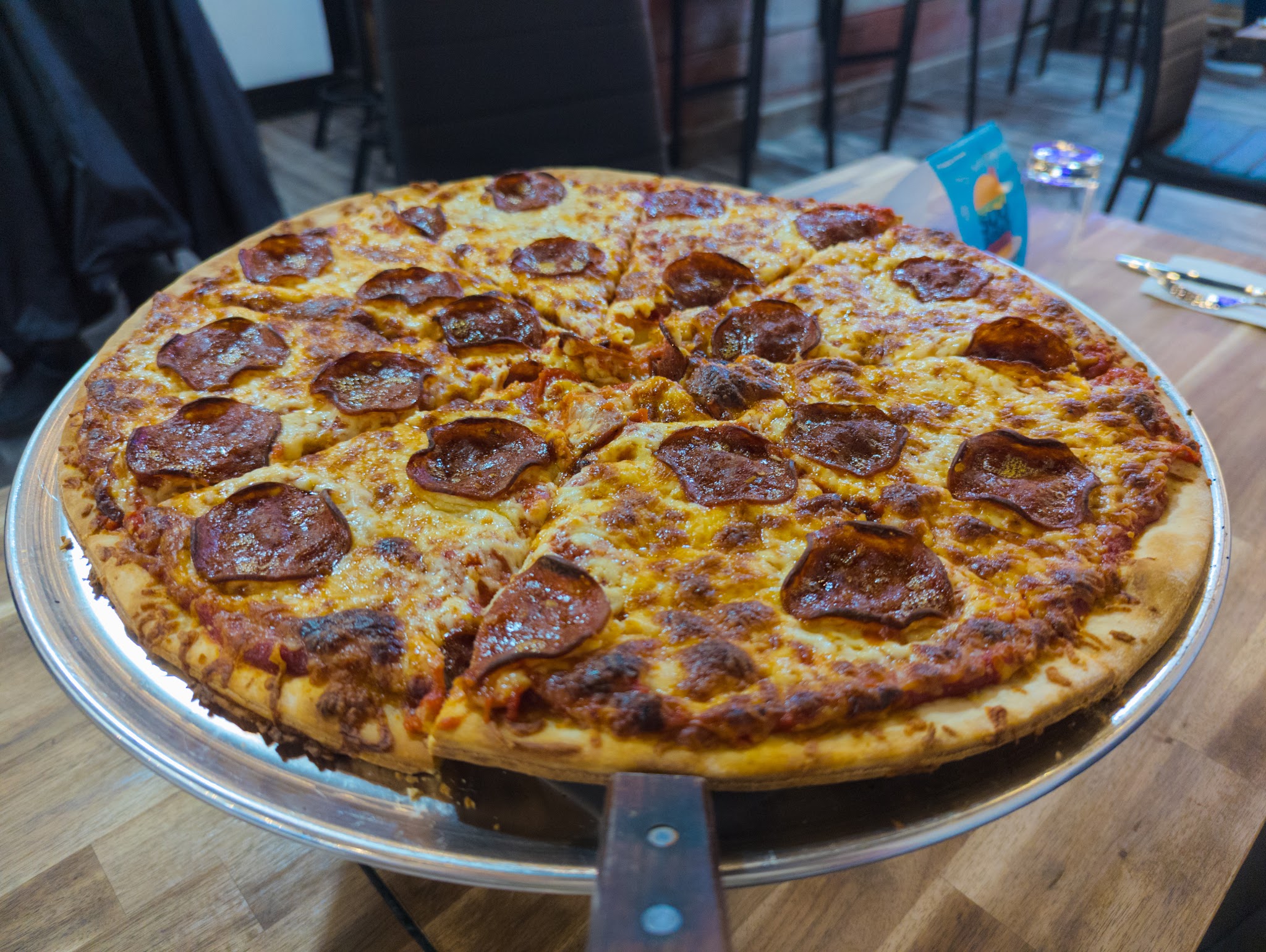 Pepperoni pizza on raised serving stand